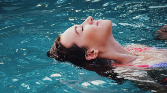 Woman doing backstroke in pool