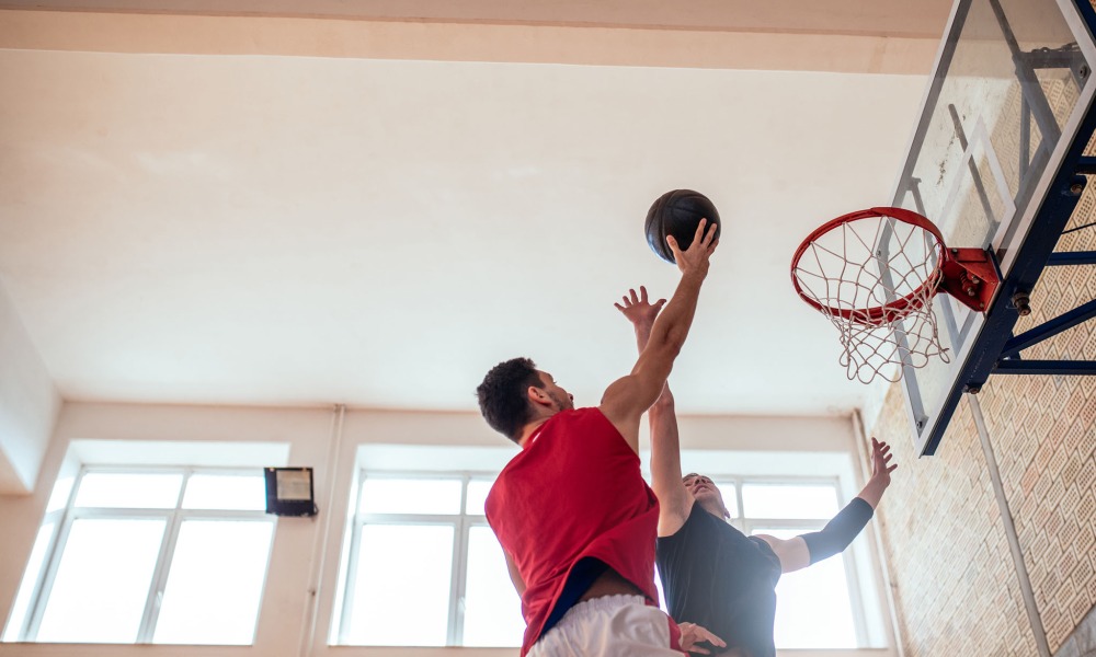 two men getting health benefits of playing adult basketball