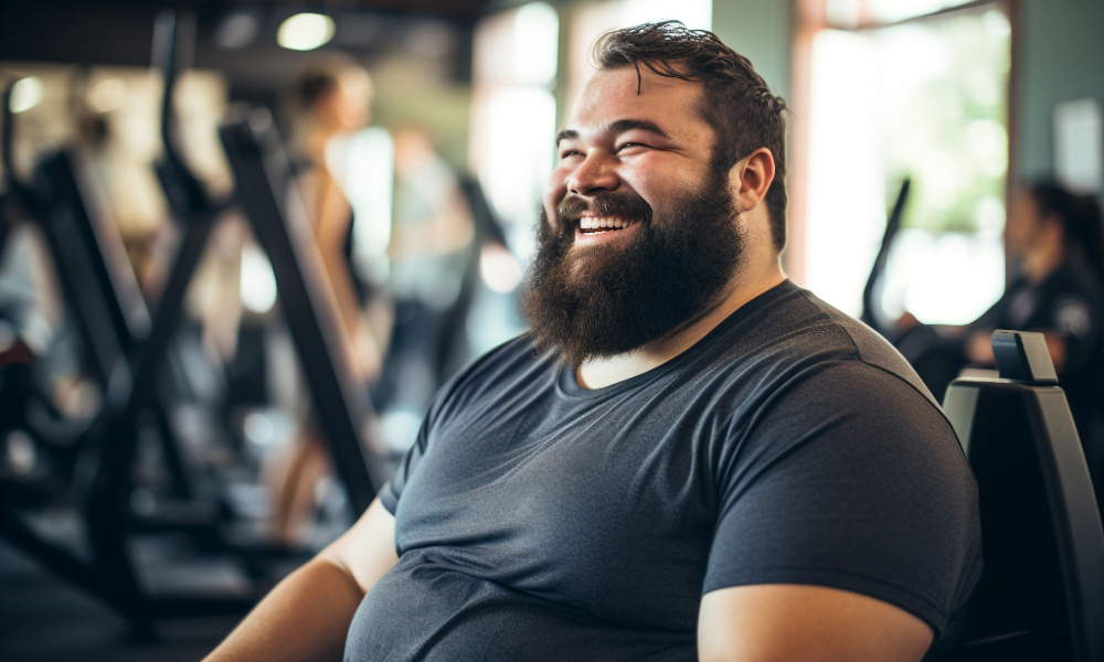 large, happy man smiling at gym because of fair membership prices